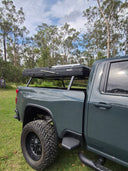 Ute with an On The Horizon hard shell rooftop tent closed on the tub rack, side on