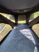 Inside an On The Horizon rooftop tent looking out through the open end at bushland