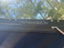 Solar panel mounted on the lid of an On The Horizon hard shell rooftop tent