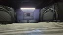 The 1.9 Penthouse lit from the interior LED strip, with the bed made up and the storage pockets on both walls