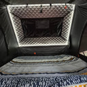 The quilted end lining and storage pockets inside the 1.5 Pro, lit by the LED strip